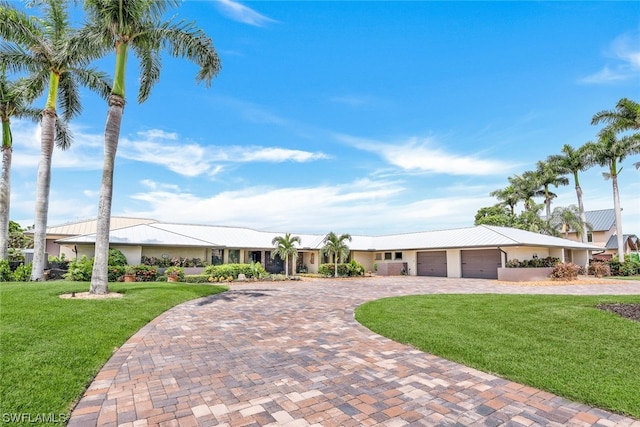 ranch-style home with a front lawn and a garage