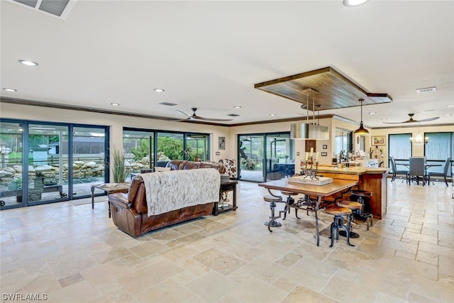 living room featuring crown molding and ceiling fan