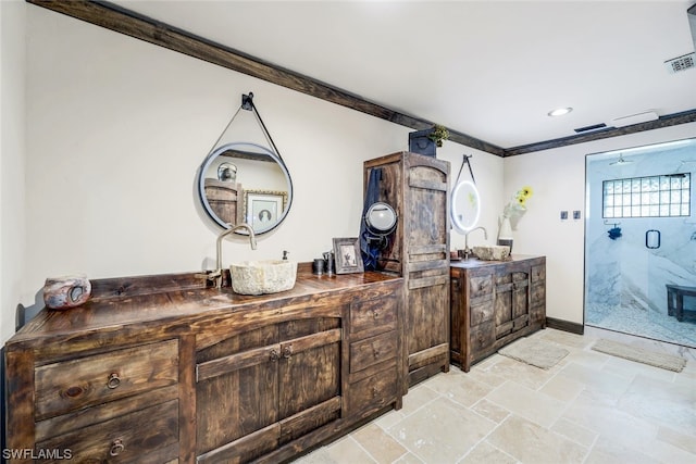 bathroom featuring crown molding, vanity, and a shower with shower door