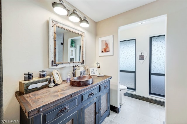 bathroom with vanity, tile patterned flooring, and toilet