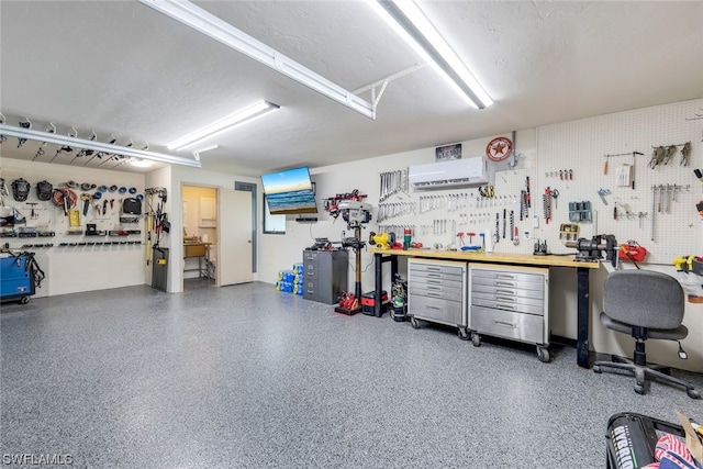 garage with a workshop area and a wall mounted air conditioner