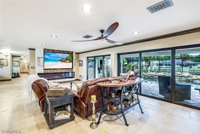 living room featuring ceiling fan and crown molding