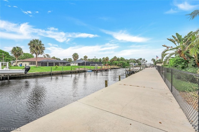 dock area featuring a water view and a lawn