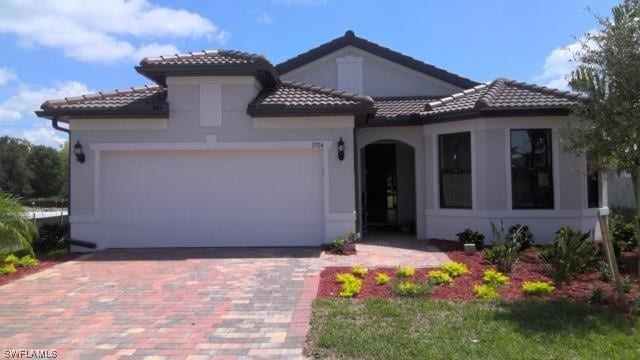 mediterranean / spanish-style home with a garage