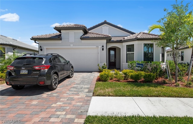 mediterranean / spanish-style house with a garage