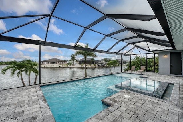 view of swimming pool featuring a lanai, an in ground hot tub, a patio, and a water view