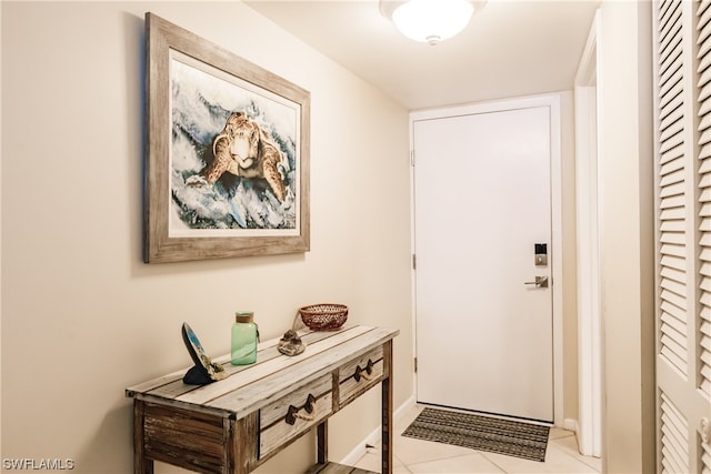 doorway to outside with light tile floors