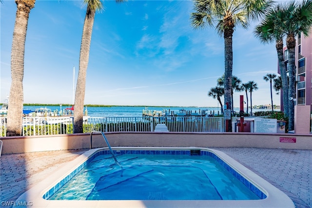 view of pool featuring a water view