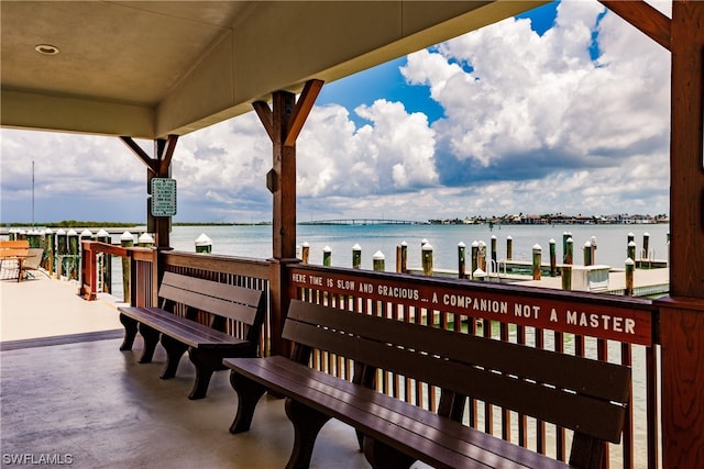 wooden terrace with a dock and a water view