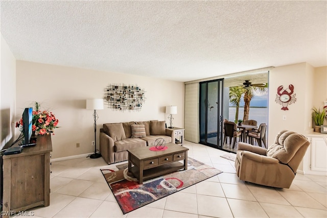 living room with light tile floors, a textured ceiling, ceiling fan, and a water view