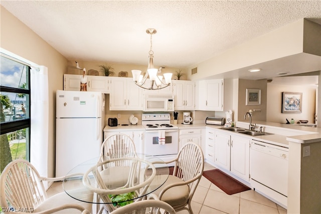 kitchen featuring white appliances, sink, an inviting chandelier, decorative light fixtures, and white cabinetry