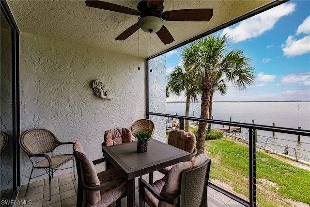 exterior space with a water view and ceiling fan