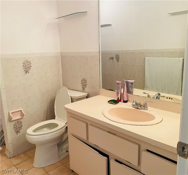 bathroom with tile walls, large vanity, tile floors, and toilet