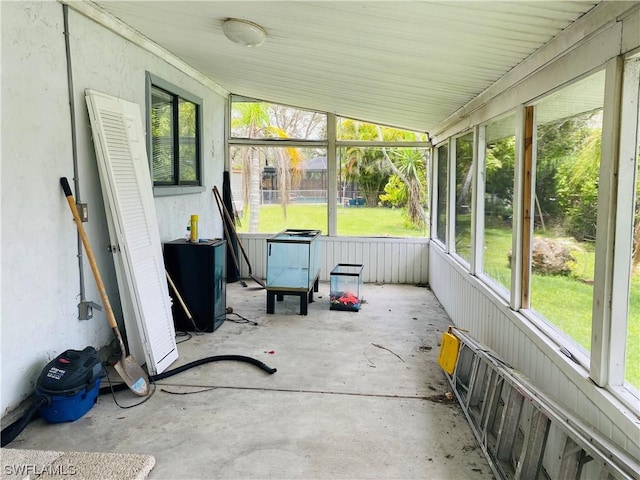 unfurnished sunroom featuring a wealth of natural light and lofted ceiling