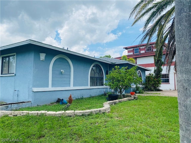 view of home's exterior with a yard