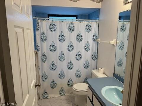 bathroom featuring a shower with curtain, vanity, tile patterned floors, and toilet