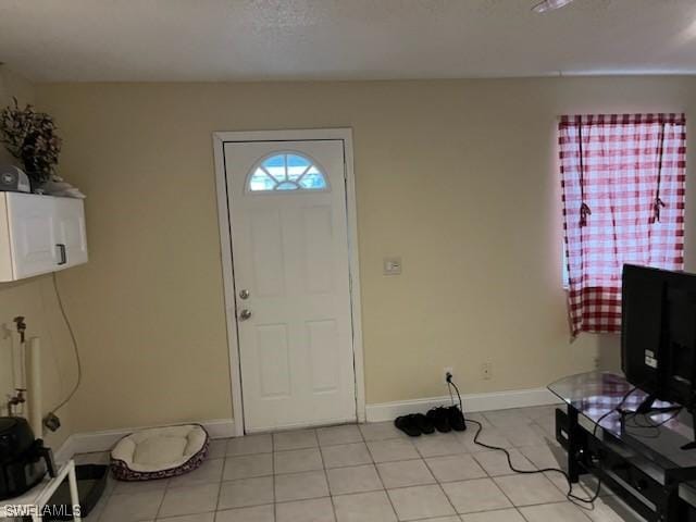 entryway with light tile patterned floors