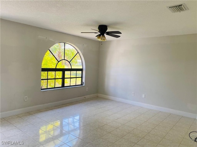 unfurnished room featuring a textured ceiling and ceiling fan