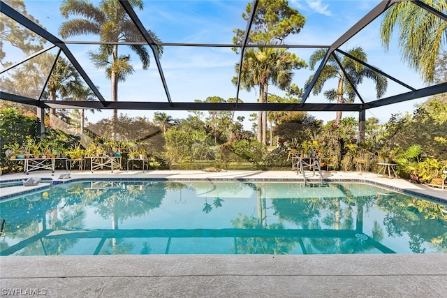 view of swimming pool featuring a lanai