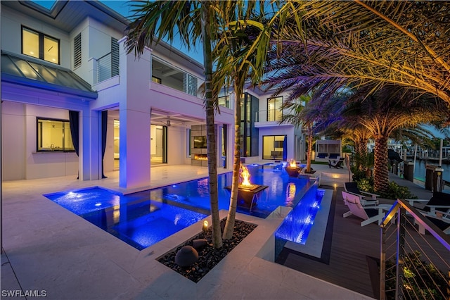 view of swimming pool featuring a patio and an in ground hot tub