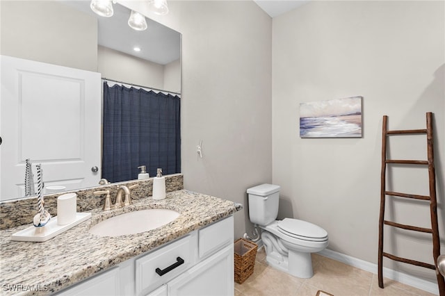 bathroom with tile patterned flooring, vanity, and toilet