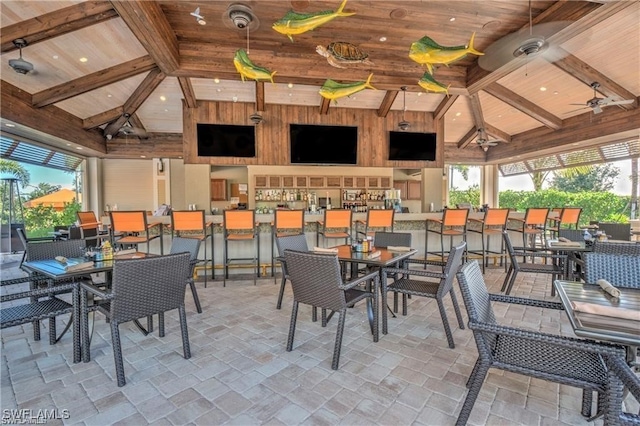 view of patio featuring ceiling fan and an outdoor bar