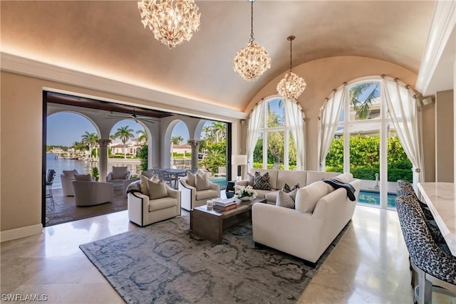 living room with a water view, lofted ceiling, and a notable chandelier