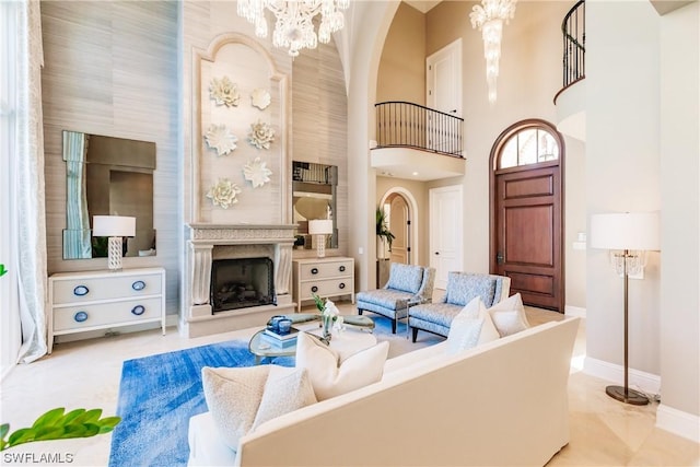 living room with a chandelier and a towering ceiling