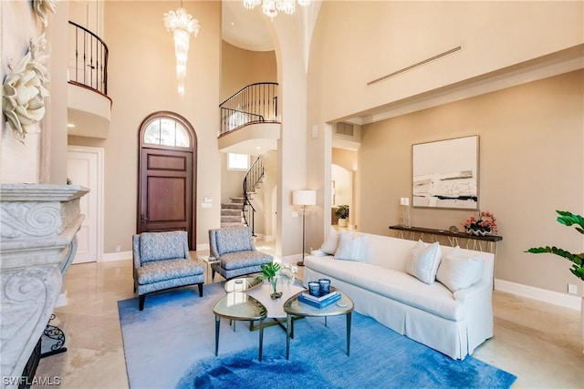 living room with an inviting chandelier and a high ceiling