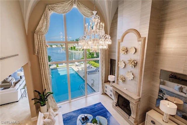 interior space featuring a water view and an inviting chandelier