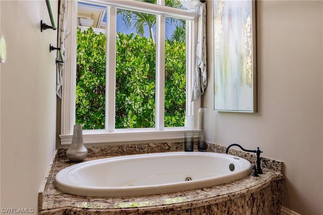 bathroom with a relaxing tiled tub