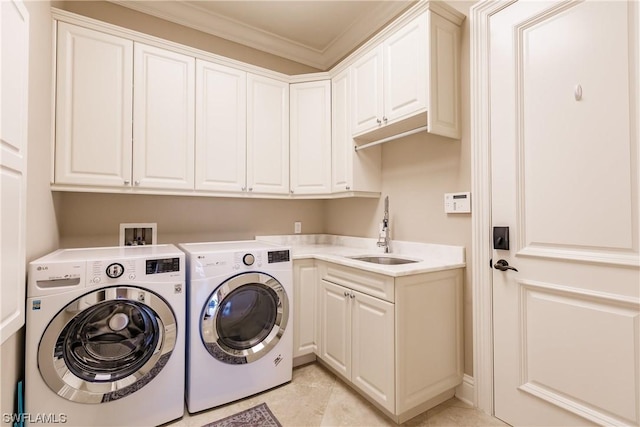 laundry area with washing machine and dryer, cabinets, sink, light tile patterned floors, and crown molding