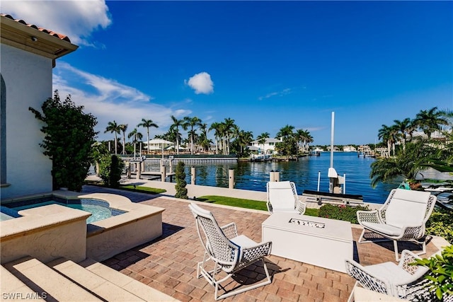 view of patio / terrace with a water view and a boat dock