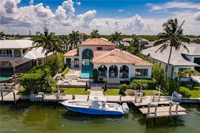 rear view of property with a water view and a patio area