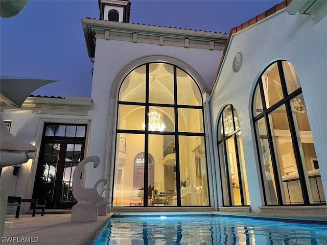 rear view of house featuring french doors