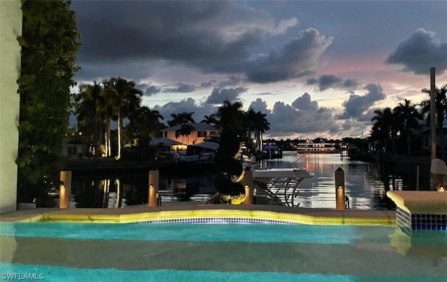 pool at dusk with a water view