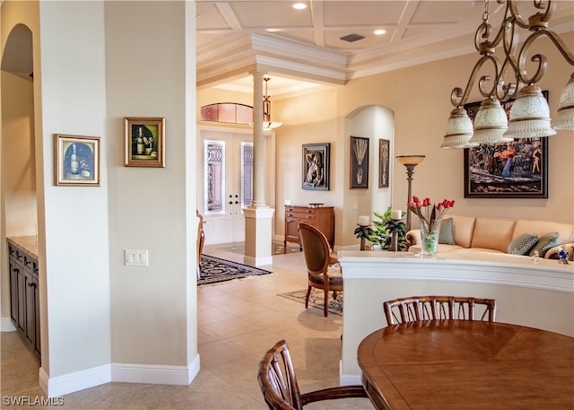 tiled dining area featuring ornamental molding, decorative columns, and coffered ceiling