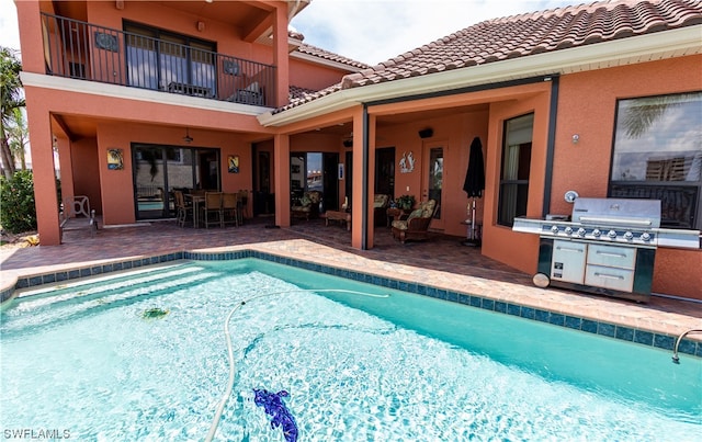 view of swimming pool with a patio area and a grill