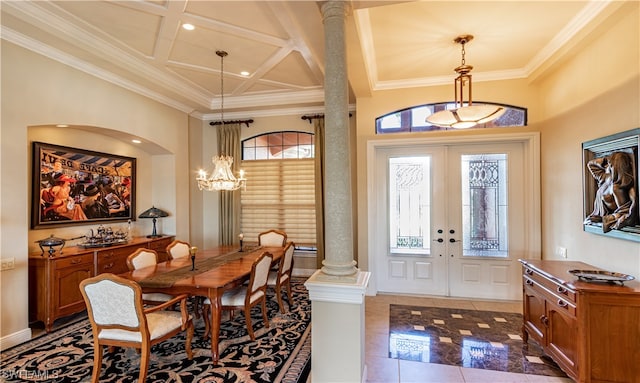 tiled dining space with decorative columns, ornamental molding, a high ceiling, french doors, and coffered ceiling