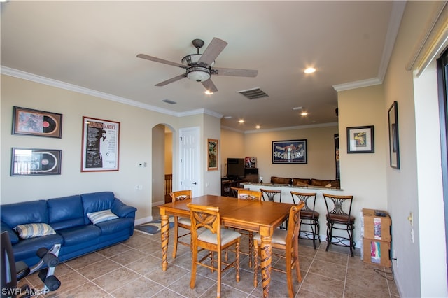 tiled dining room featuring crown molding and ceiling fan