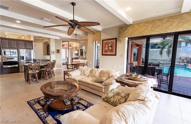 tiled living room featuring beamed ceiling and ceiling fan