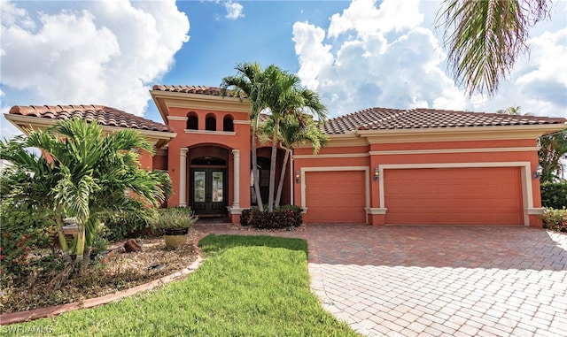 mediterranean / spanish-style house featuring french doors and a garage