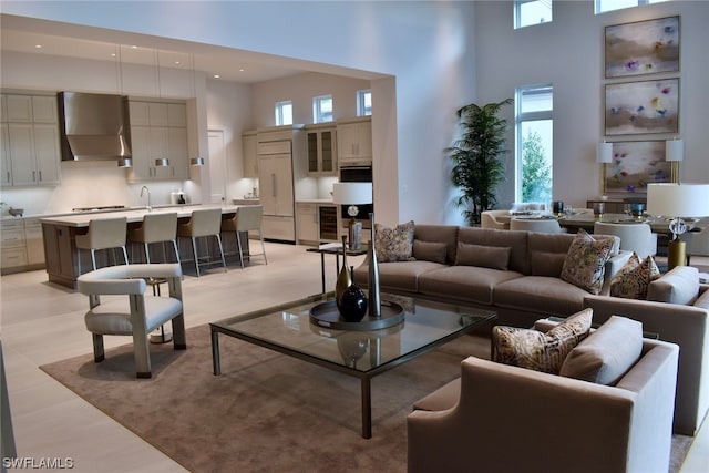 living room with wine cooler and a towering ceiling