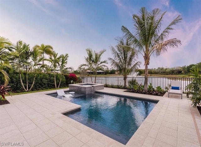 view of swimming pool featuring an in ground hot tub, a patio area, and a water view