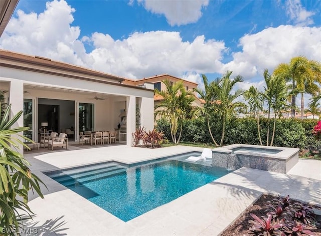 view of pool featuring ceiling fan, a patio area, and an in ground hot tub