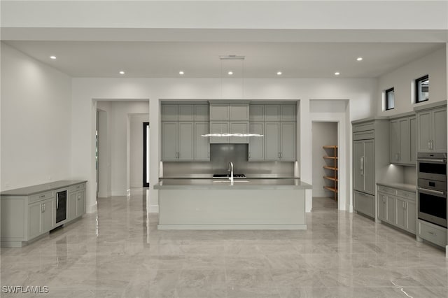 kitchen with sink, gray cabinets, built in refrigerator, wine cooler, and stainless steel double oven