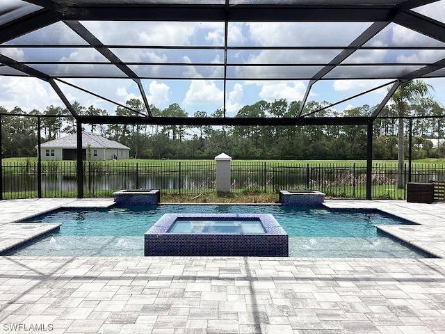 view of swimming pool with an in ground hot tub, a patio, and a lanai