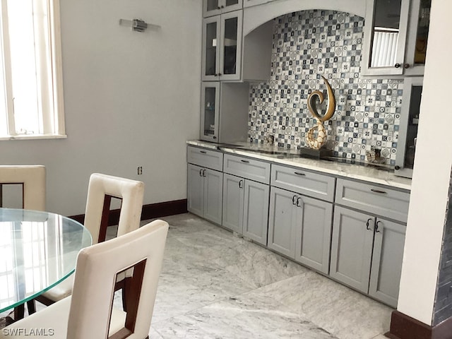 kitchen with tasteful backsplash, gray cabinets, and light tile floors