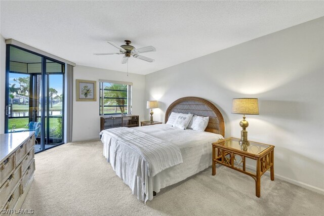 carpeted bedroom featuring ceiling fan, a textured ceiling, and access to outside