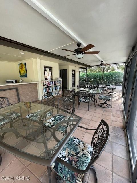 dining space featuring lofted ceiling, ceiling fan, and light tile patterned flooring